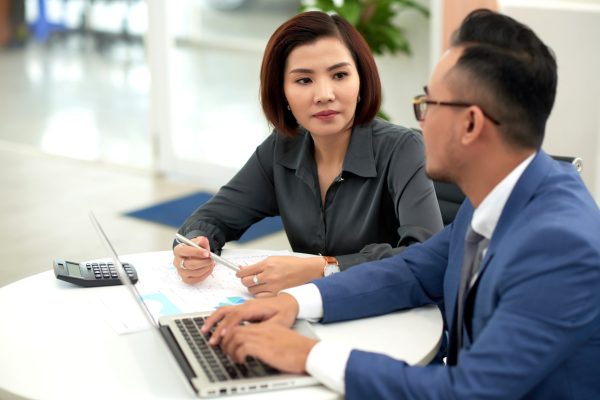 Couple consulting on Long-Term Visit Pass and Dependant Pass options in Singapore.